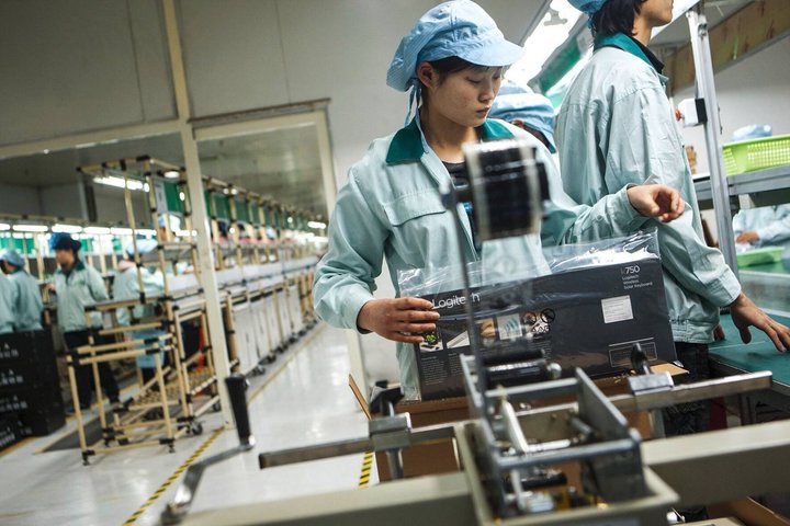 Workers package keyboards at the Logitech International SA factory in Suzhou, Jiangsu Province, China, on Friday, March 2, 2012. Logitech manufactures personal computer input devices including computer mice and keyboards. Photographer: Nelson Ching/Bloomberg