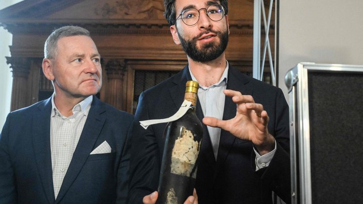 Yquem-Önologe Toni El Khawand (rechts im Bild) präsentiert eine der sorgfältig restaurieren Flaschen.