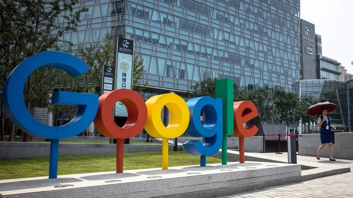 epa06994628 (FILE) - A Chinese woman walks past a 'Google' brand name and logo, near the Google office in Beijing, China, 03 August 2018 (reissued 03 September 2018). Google marks its 20th anniversary on 04 September 2018, the date in 1998 when Google founders Larry Page and Sergey Brin incorporated the company. The stock market value of Alphabet (parent company of Google) currently is 688 billion USD.  EPA/ROMAN PILIPEY
