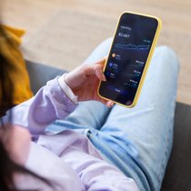 Person trading cryptocurrency on smartphone app