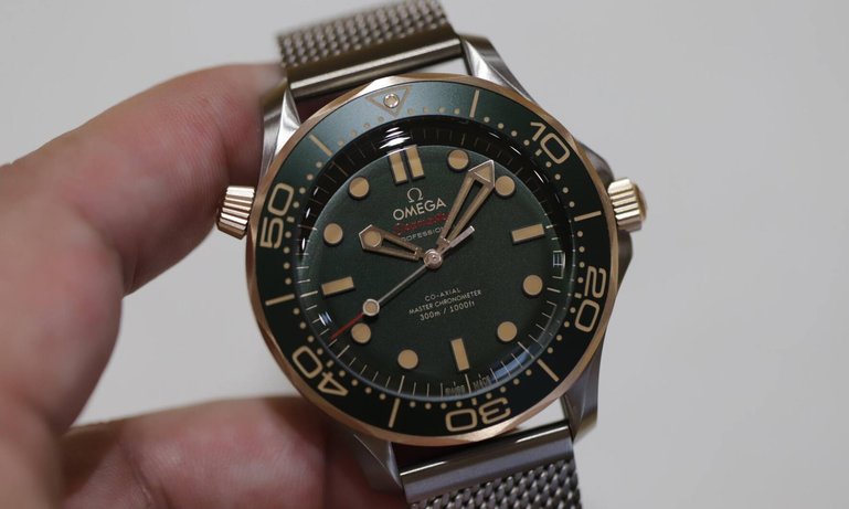 Die letzte, 2024 vorgestellte Variante der Seamaster Diver 300M verbindet erstmals ein mattes Titangehäuse, ein grünes Aluminium-Inlay und Zifferblatt mit Bronze-Gold für Krone, Heliumventil und Drehring.