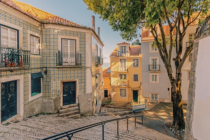 Street with tile decorated residential houses in Alfama district, Lisbon, Portugal